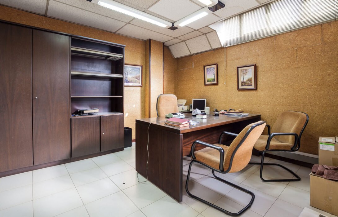 1960´s style bosses office with cabinets, chairs, telephone, calculator and cabinet