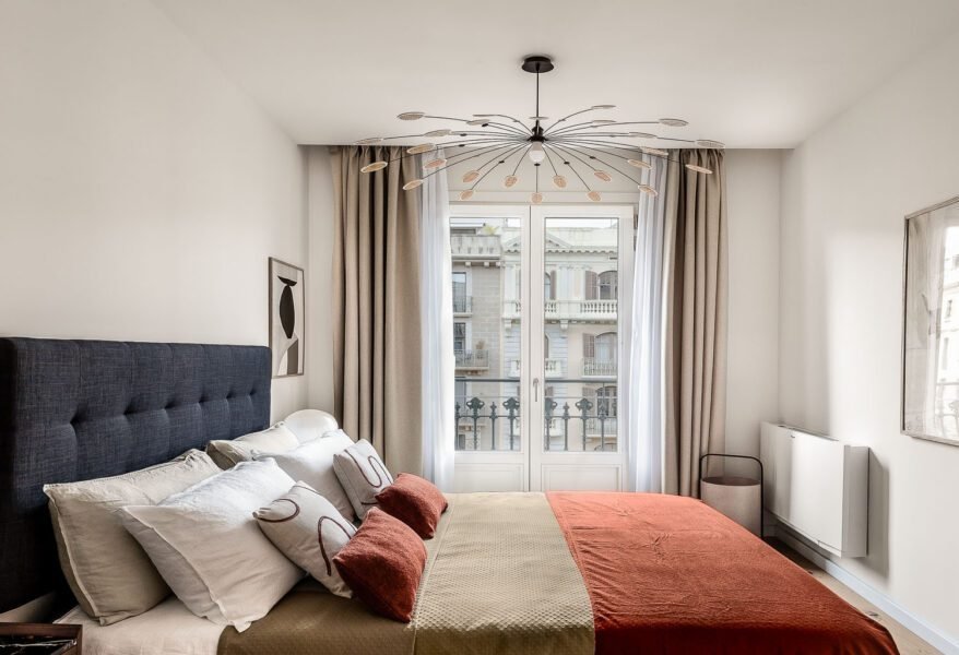 Hotel room warm ambient lighting decorated in complementary orange and blue with french door