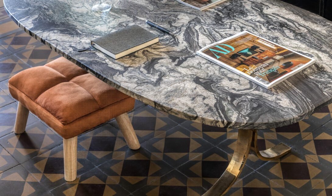 Stunning 1970´s marble coffeetable by Marc d´haenens styled with a burnt orange stool and architectural digest magazine for editorial look.