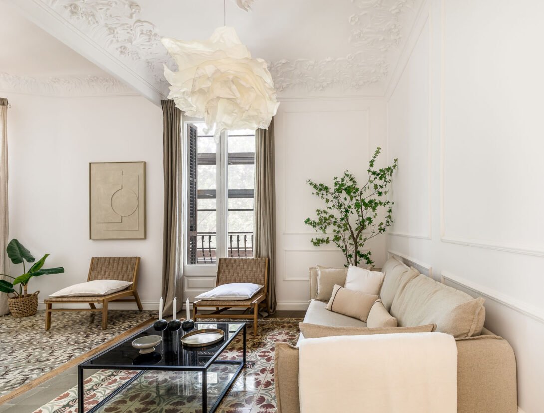 A Barcelona Residential living room with flowered sculpted cornices sofa, coffee table and modern seating in modern styled interior