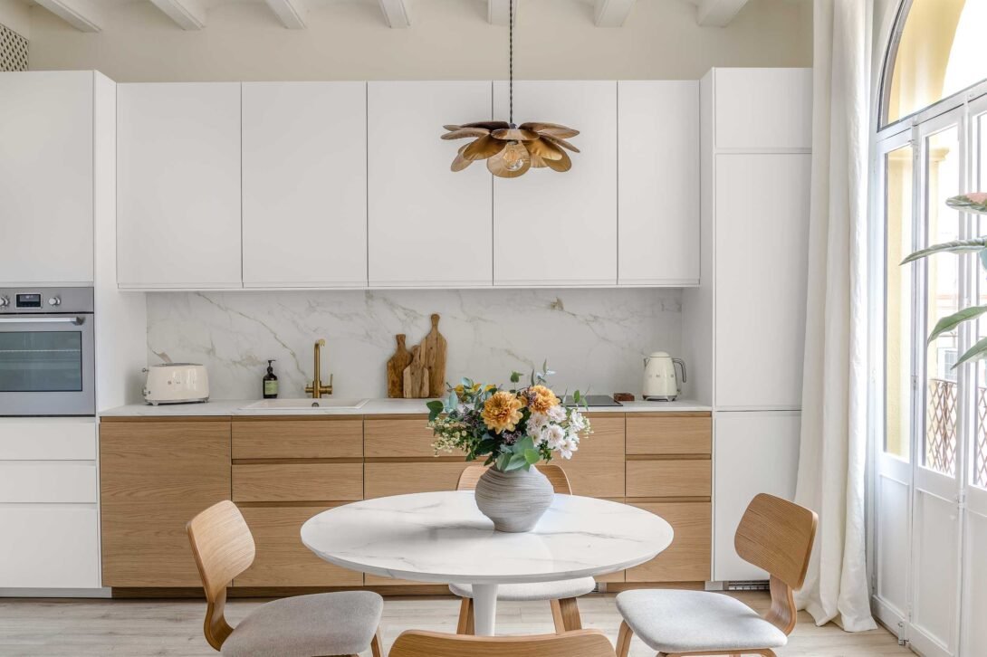 scandi style kitchen diner decorated in marble and natural wood with ambiant natural soft light