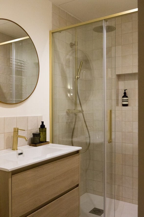 full length vintage bathroom designed with gold shower units, mirrror and gold taps