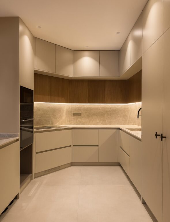 oat coloured, ergonomic bespoke kitchen cabinets, warm spot lighting, cream tiles floor in contemporary kitchen in barcelona