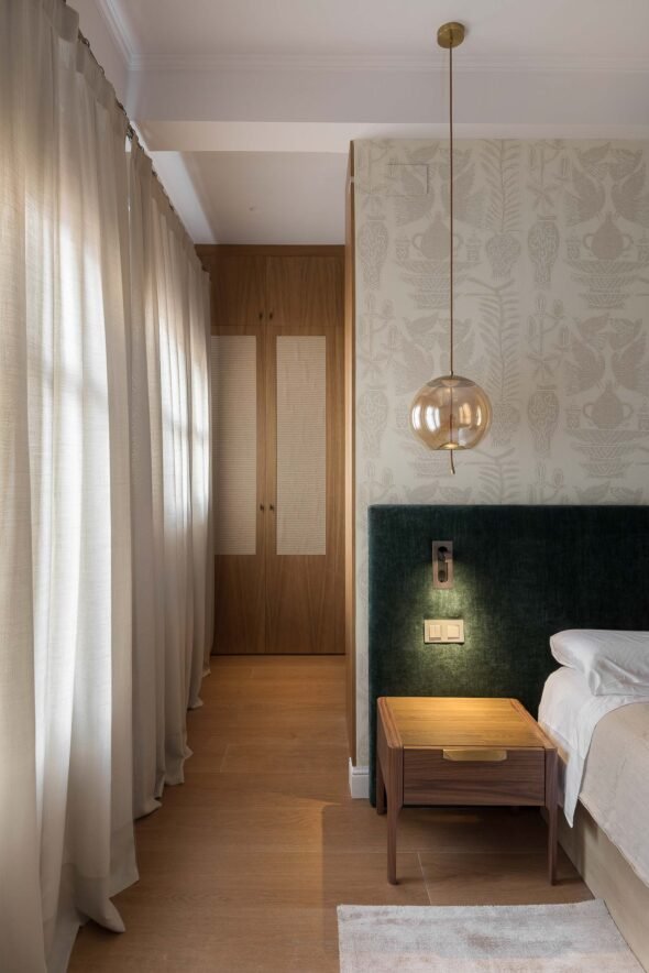 cosy bedroom, dark wood, forest green velvet combintion and smoked pendant lighting with Japanese styled wooden doors