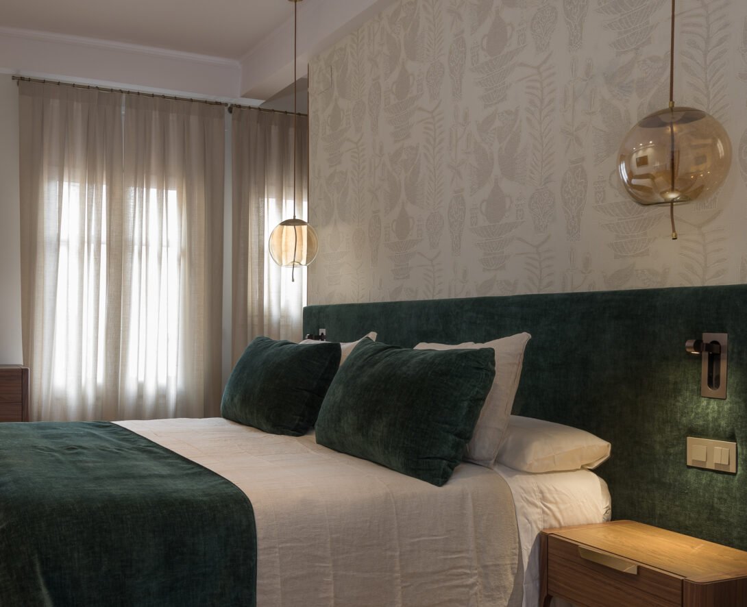 cosy bedroom, dark wood, forest green velvet combintion and smoked pendant lighting with Japanese styled wooden doors