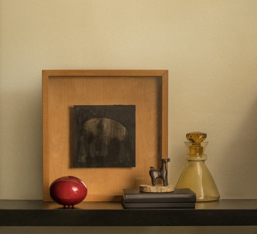 red-ceramic-ball-artwork-in-a-wood-frame-yellow-decanter-ceramic-llama